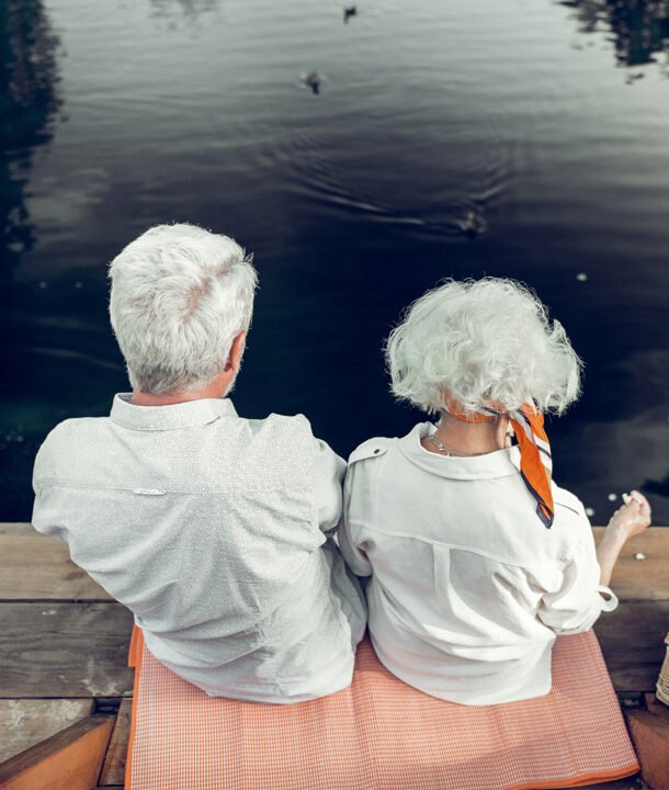 Back shot of spouses spending time on the lake